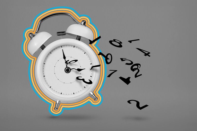 Alarm clock ringing surrounded by numbers